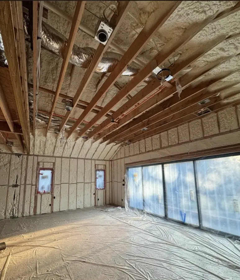 Interior walls and ceiling insulated with spray foam during new construction in Atkinson